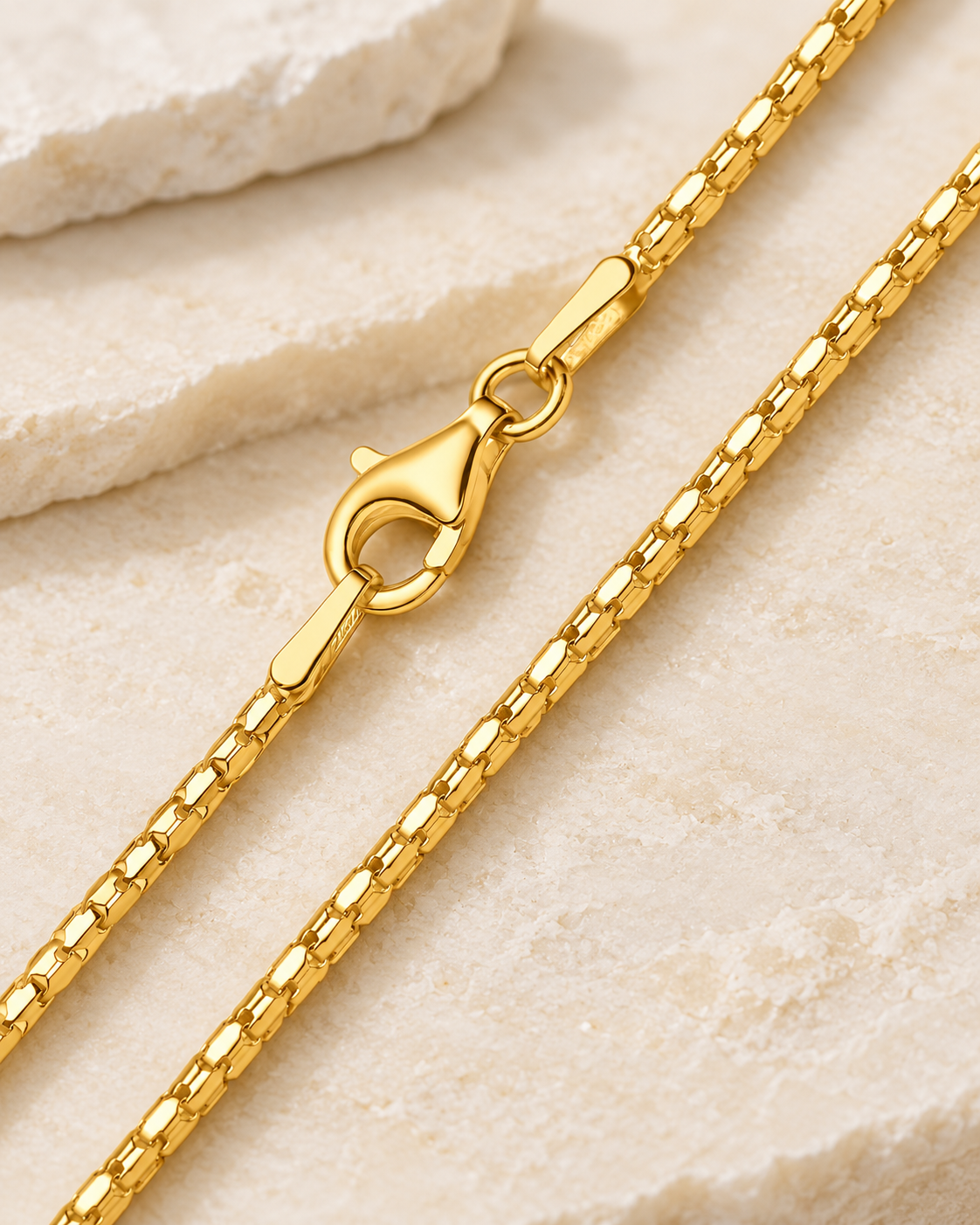 30 inch gold premium coreana chain with lobster clasp on cream stone.