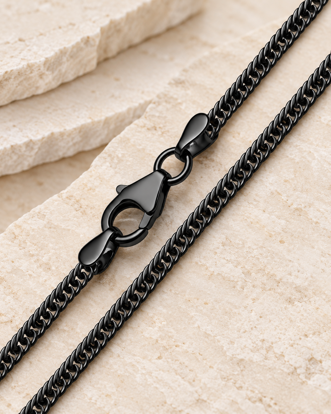 28 inch black premium men's curb chain with lobster clasp on cream stone.