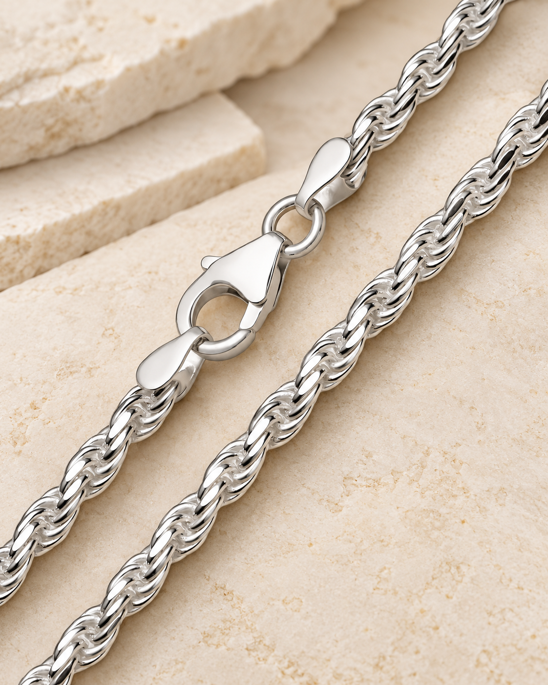28 inch silver premium men's rope chain with lobster clasp on cream stone.
