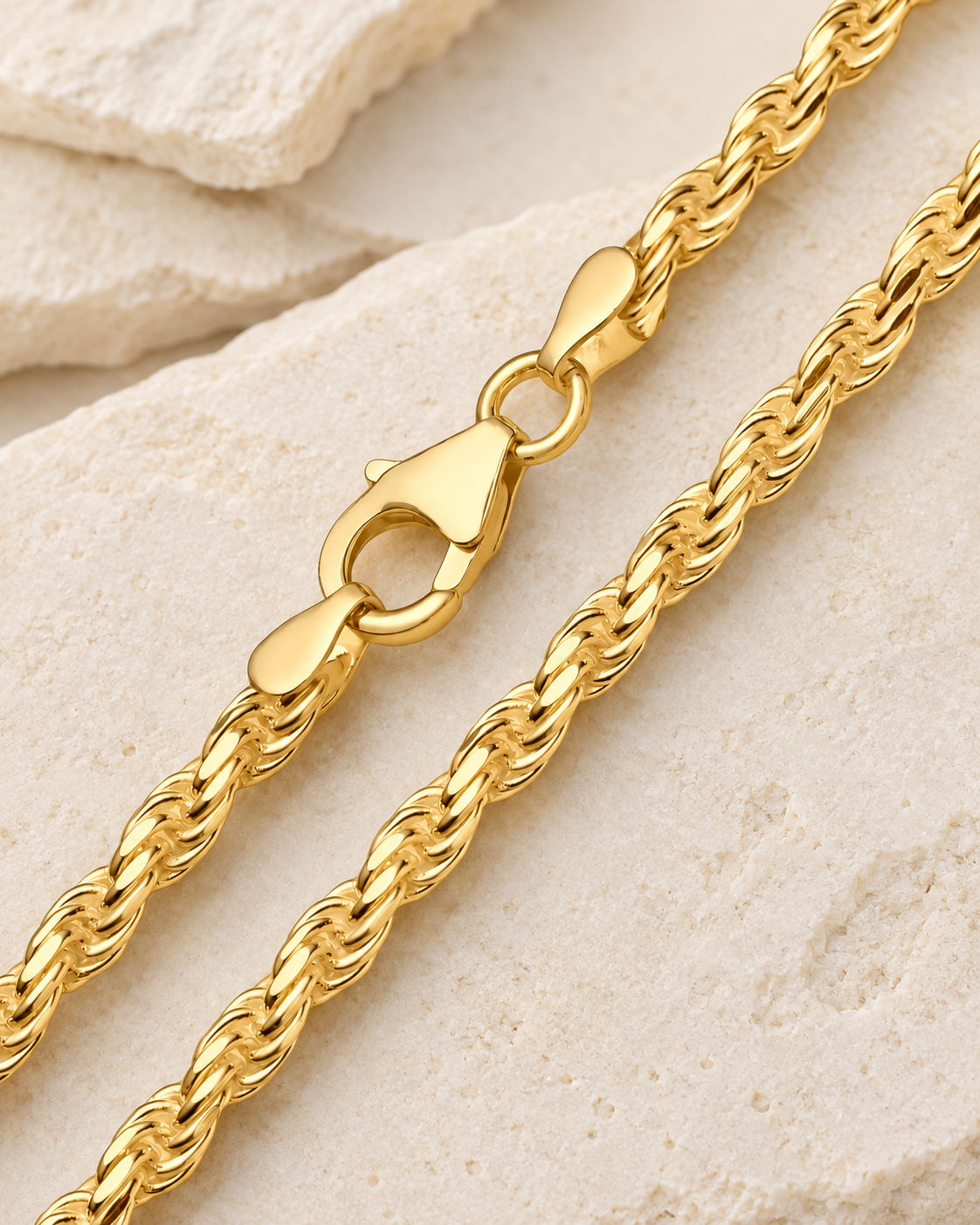 28 inch gold premium men's rope chain with lobster clasp on cream stone.
