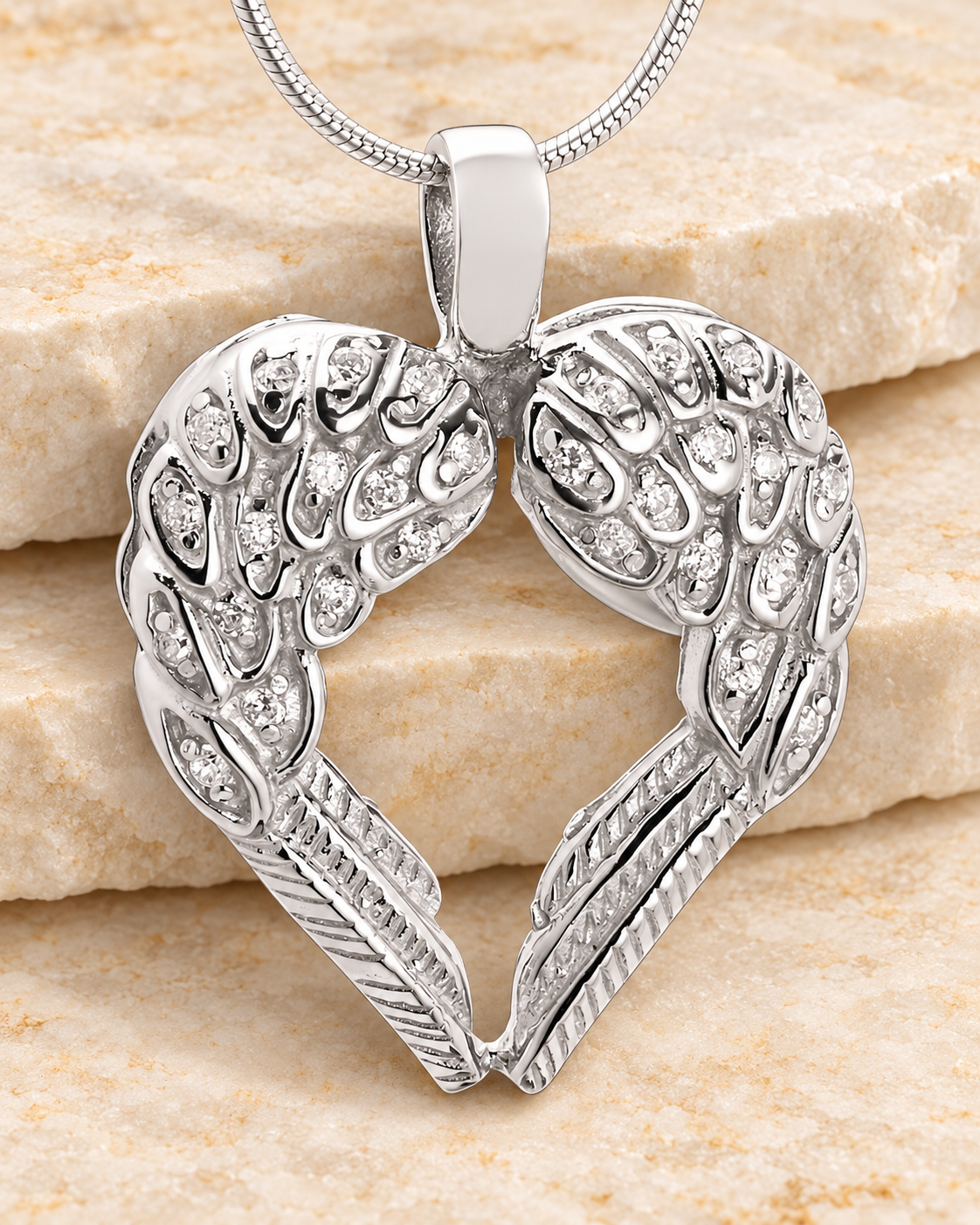 Wings of Hope Memorial Jewelry on a cream stacked-stone background