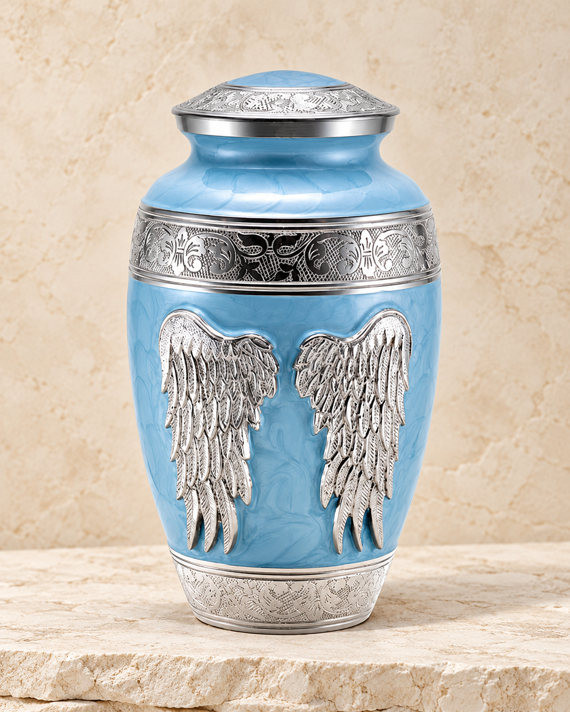 blue angel wings individual cremation urn on cream stacked stone, portrait product photograph