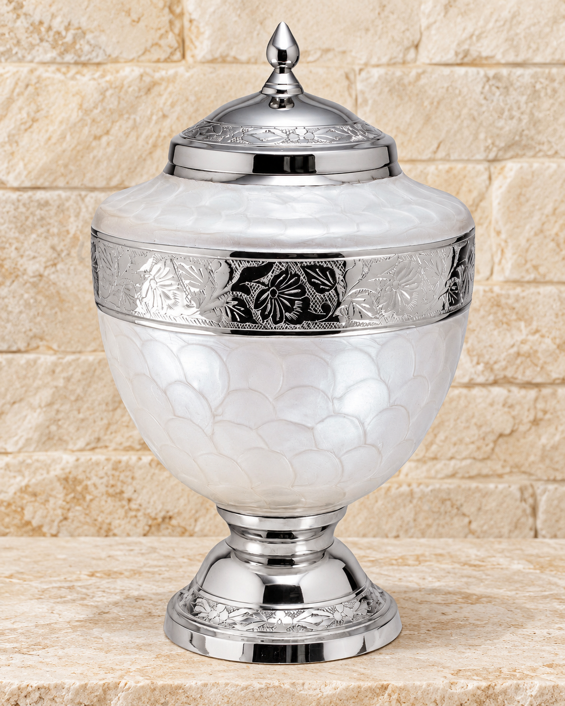 pearl white majestic cremation urn on cream stacked stone, portrait product photograph