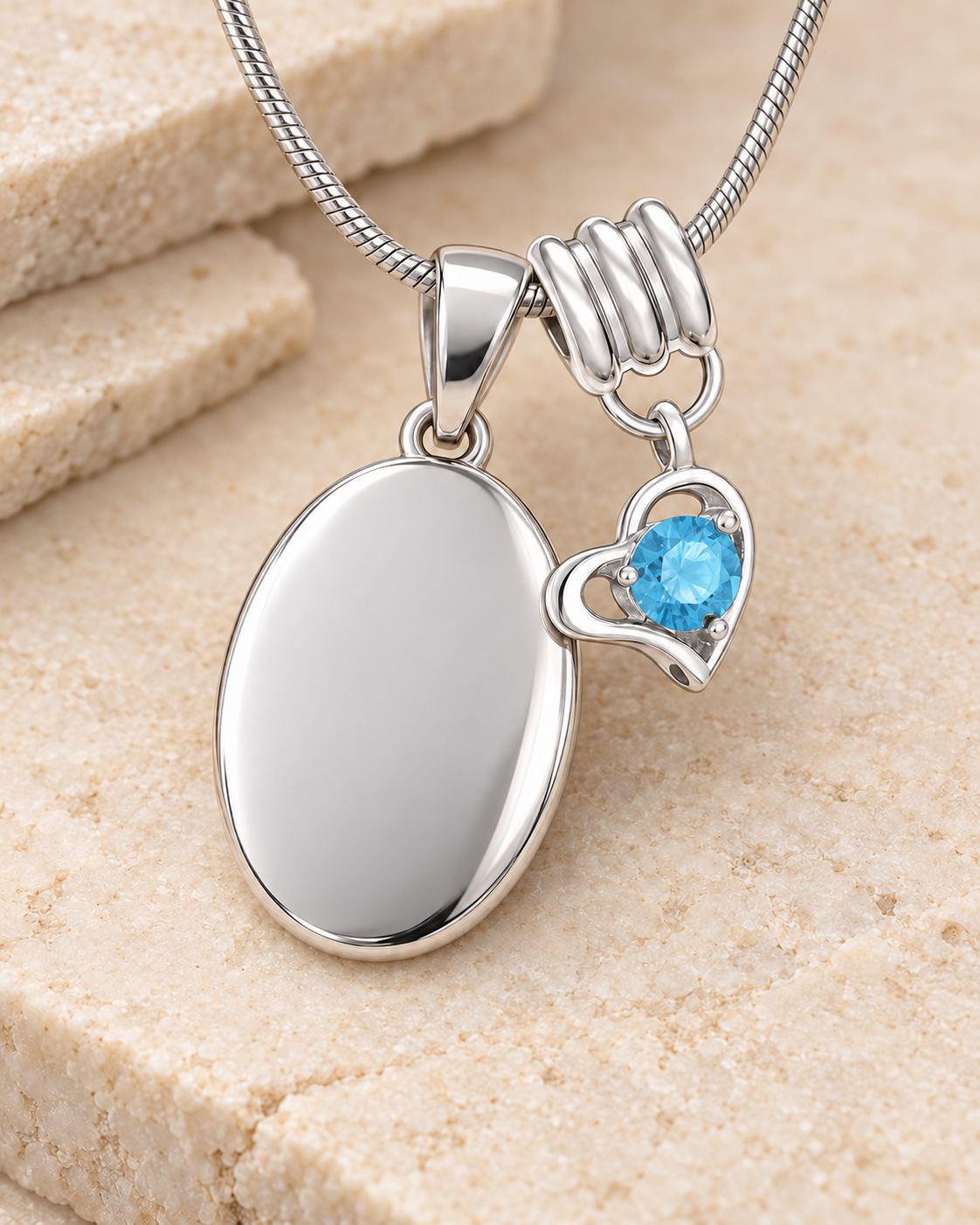 December silver birthstone heart hanger with an illustrative matching oval pendant; display pendant and chain sold separately.
