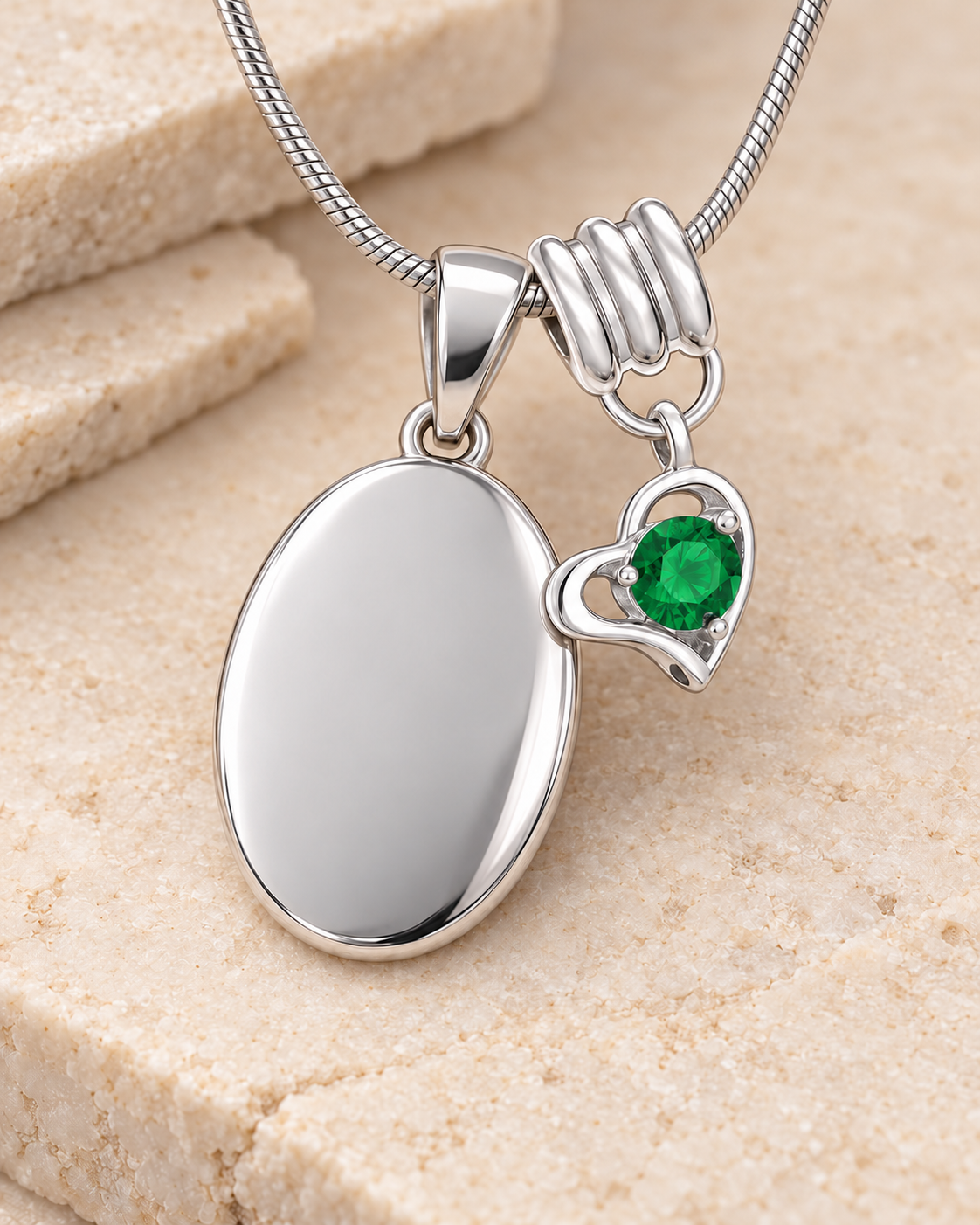 May silver birthstone heart hanger with an illustrative matching oval pendant; display pendant and chain sold separately.